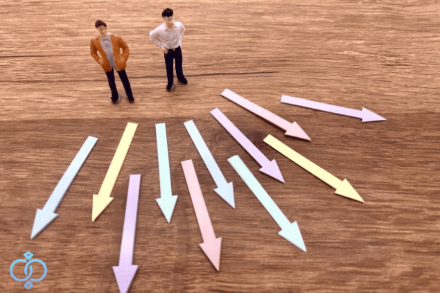 無数の矢印の後ろに立つ二人の男性人形
たくさんの選択肢がある中で迷っている様子を表現したイメージ画像