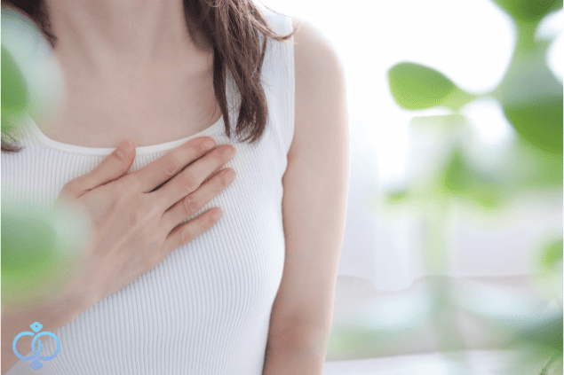 胸に手を当てる女性の画像